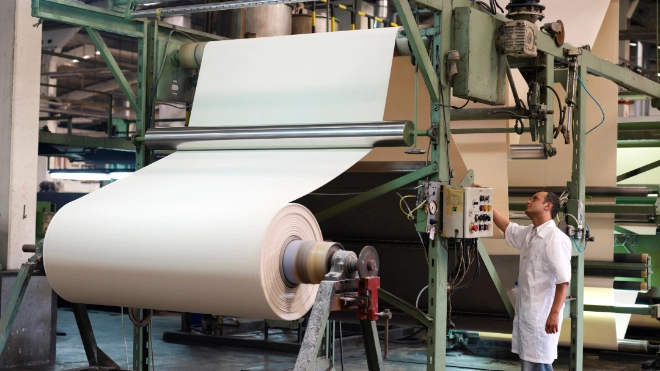 male worker using a paper processing machine