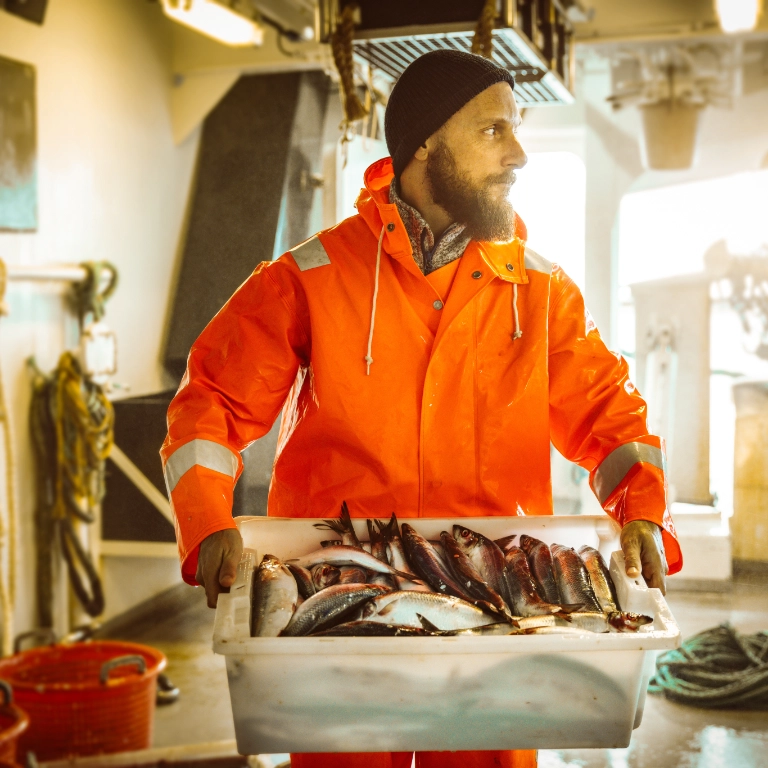 Fisherman holding a tray of fish