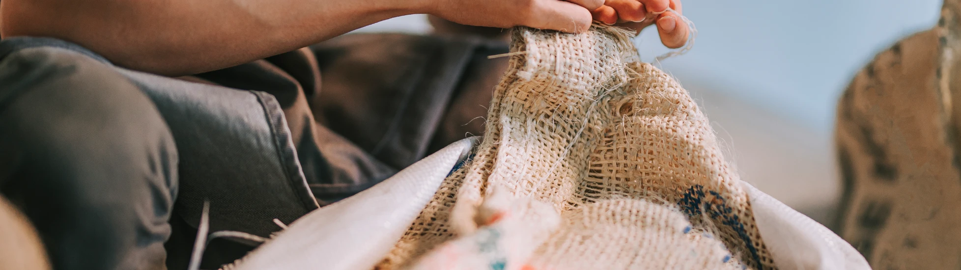 Coffee bean worker fixing a sack