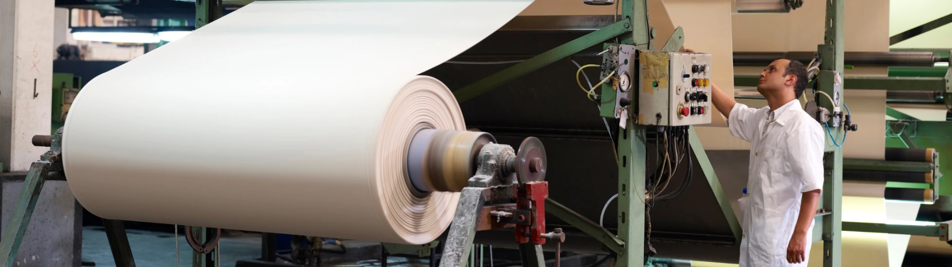 male worker using a paper processing machine