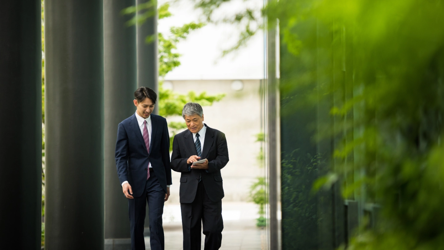 Colleagues strolling in greenery Colleagues strolling in greenery