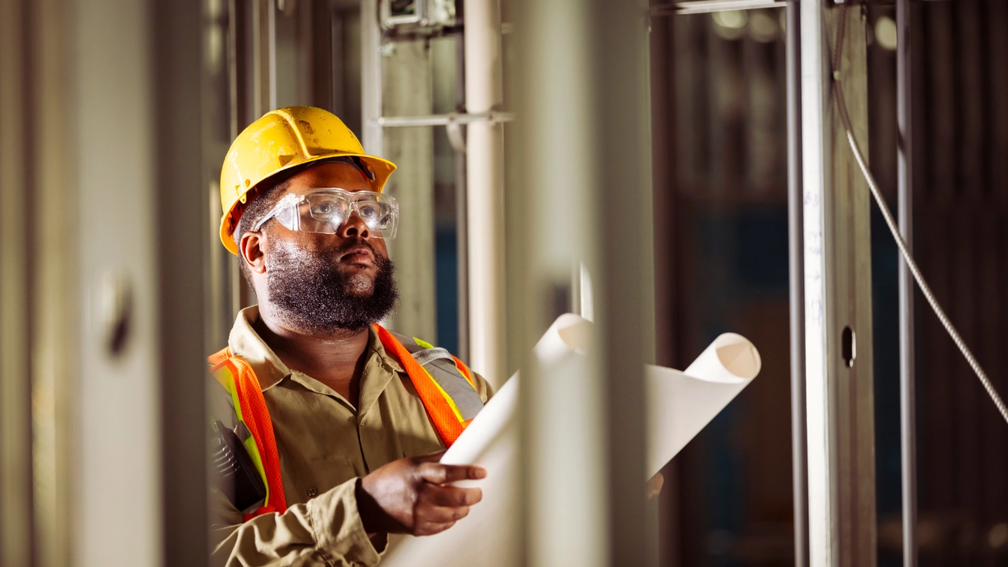 Construction worker reviewing drawings