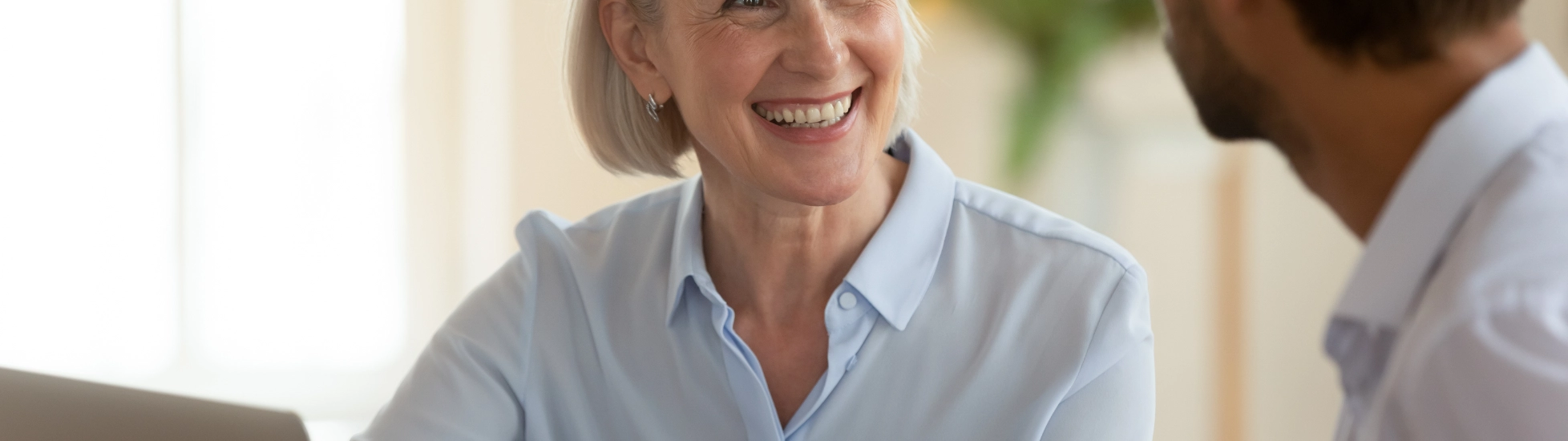 Middle aged woman talking to a male colleague