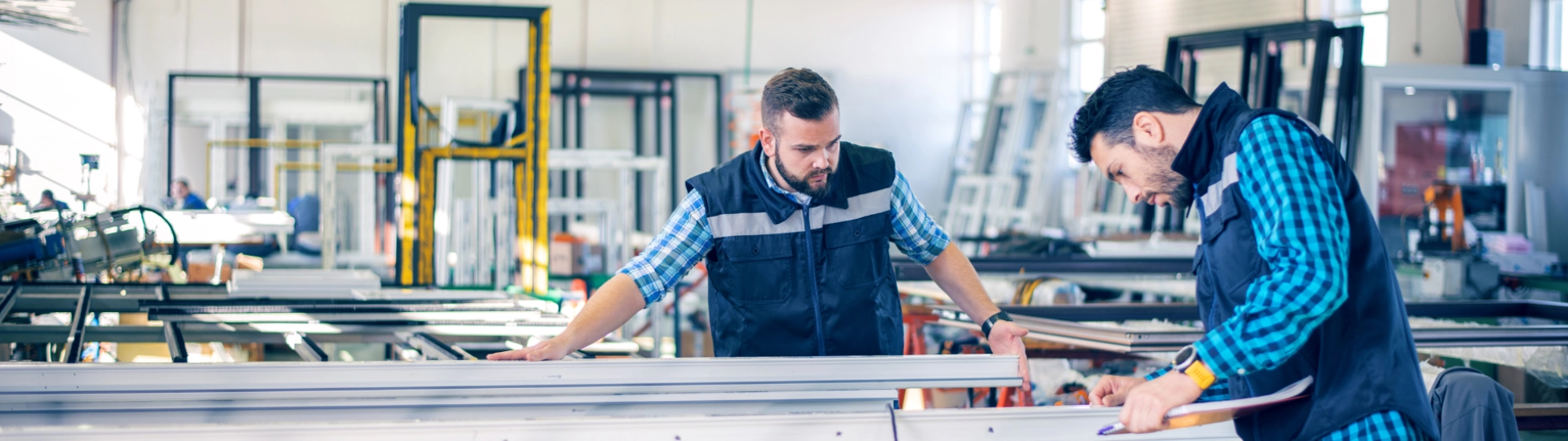Manufacturing plant workers checking invoices
