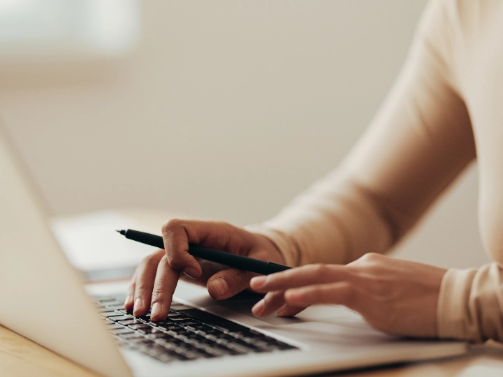 Close-up of Asian woman working on a laptop